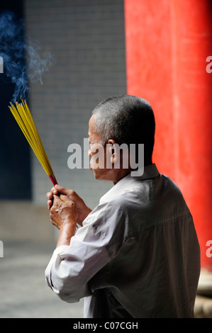 Mann mit Weihrauch steckt in chinesischen Tempel, Chua Thien Hau Pagode, Cho Lon, Chinatown, Ho Chi Minh Stadt, Saigon, Südvietnam Stockfoto