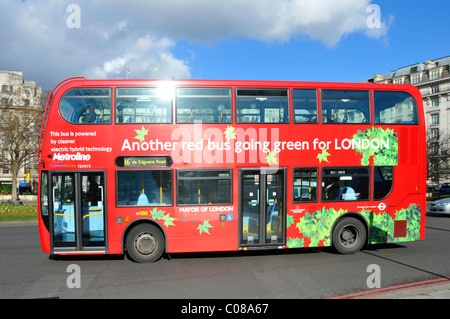 Seitenansicht des roten Doppeldecker-Passagierbusses Going Green Für den öffentlichen Verkehr in London & powered by a Cleaner Elektrische Hybrid-Technologie England Großbritannien Stockfoto