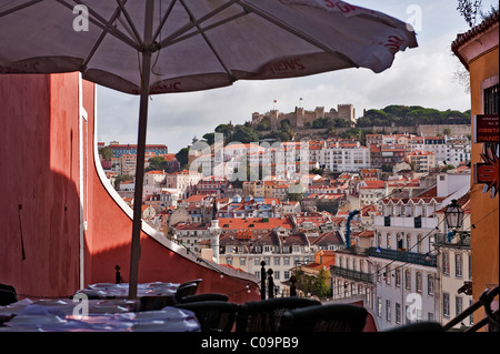 Tische in einem Restaurant in der Calcada Duque, Viertel Bairro Alto, in den Rücken den Schlossberg mit der Burg Castelo Sao Jorge Stockfoto
