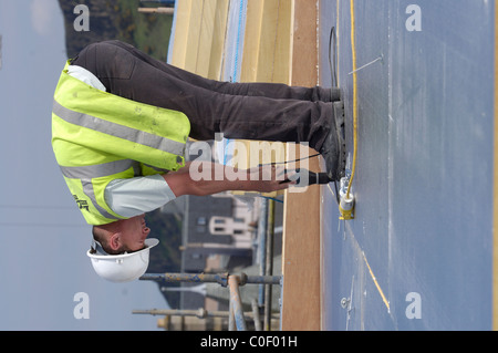 Dachdecker auf Dach verlegen Filz Stockfoto