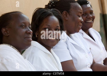 Eine Gruppe von Krankenschwestern sitzen außerhalb einer Klinik in Kampala, Uganda, Ostafrika. Stockfoto