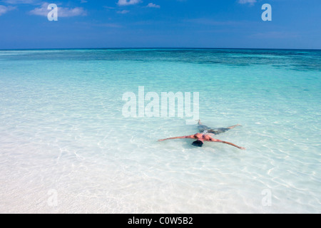 Eine Person legt Gesicht sich in dem smaragdgrünen Wasser der Similan Marine Nationalpark, Thailand. Stockfoto