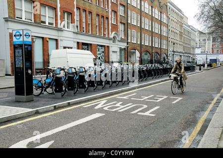 Weibliche Radfahrer Reiten eigenen Fahrrad vorbei Barclays Cycle Hire Punkt in Bloomsbury London England K Stockfoto