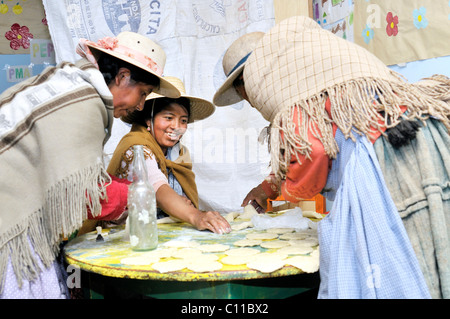 Frauen in traditioneller Tracht des Quechua vorbereiten gebratene Knödel, bolivianischen Altiplano Hochland, Departamento Oruro, Bolivien Stockfoto