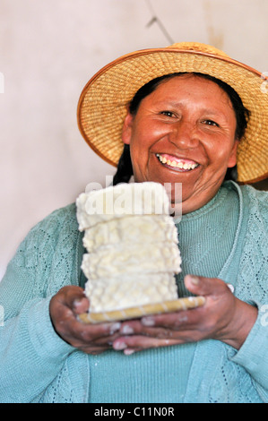 Herstellung von Frischkäse im Tal Penas, lachende Frau präsentiert Käse, Departamento Oruro, Bolivien, Südamerika Stockfoto