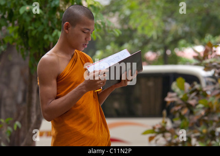 Myanmar (aka Burma), Mandalay, Amarapura. Mahagandayone Kloster, das größte Kloster in Myanmar. Mönch zu lesen. Stockfoto