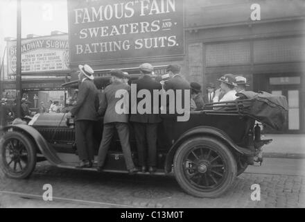 Männer fahren auf den Trittbrettern von einem improvisierten Nahverkehr Fahrzeug während eines Streiks in Brooklyn, ca. 1915. Stockfoto