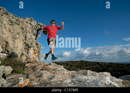 Mann läuft über felsiges Gelände im Naturpark des Cap de Creus, Katalonien, Spanien Stockfoto