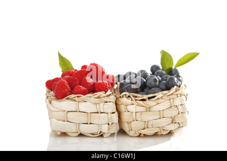 Himbeeren und Heidelbeeren im Bast Körbe Stockfoto