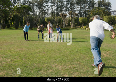 Familie spielen Cricket in Rasen Stockfoto