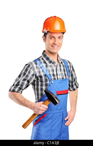 Arbeiter blauen overall trägt und hält einen hammer Stockfoto