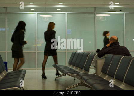 Mann beobachtet Stewardessen am Flughafen Kiew, Ukraine Stockfoto