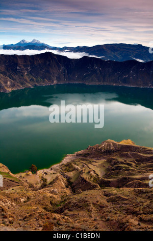 Quilotoa Kratersee bedeckt am frühen Morgen mit klaren (und seltenen) Blick auf Illiniza Schnee Gipfel (oben links), Ecuador-Anden Stockfoto