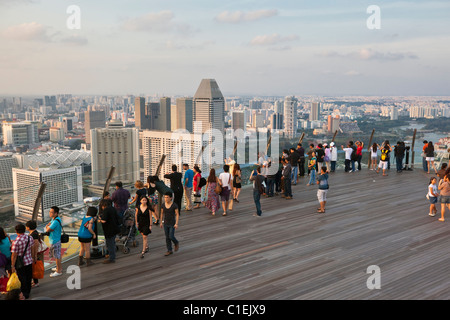 Besucher blicken auf die Skyline von Singapur von Aussichtsplattform des Marina Bay Sands SkyPark.  Marina Bay, Singapur Stockfoto