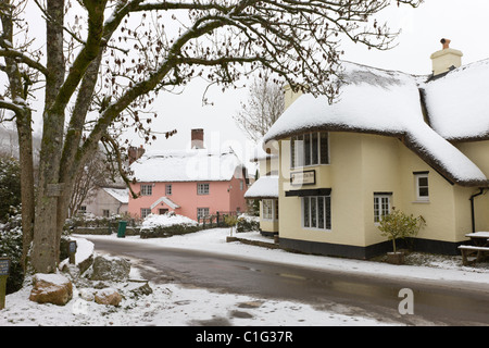 Schneebedeckte Country-Pub und Cottages im Dorf Winsford, Exmoor National Park, Somerset, England. Stockfoto