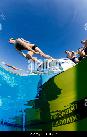 Männliche Schwimmer in den Startlöchern erwartet den Startschuss in eine Veranstaltung bei der jährlichen Orange Schüssel schwimmen Classic Stockfoto