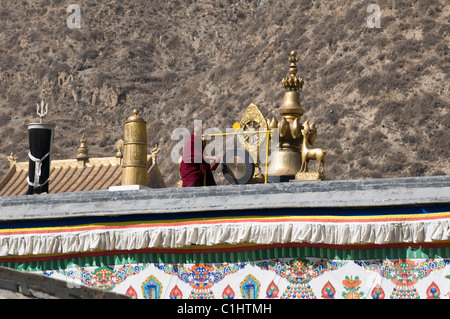 Ein Hauptmönch trifft die große Glocke, die die Mönche für ein Gebet-Sitzung gefordert. Stockfoto