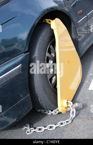 Gelbe Polizei Klemme am Rad der unversteuerten Auto Stockfoto