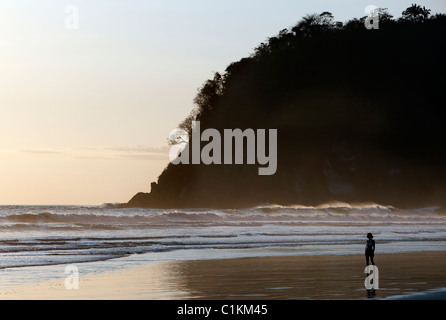 Eine Frau am Strand bei Sonnenuntergang, Playa San Miguel, Halbinsel Nicoya, Costa Rica Stockfoto