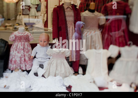 Kleine Mädchen smocked Kleider zum Verkauf in einem Schaufenster in Paris Stockfoto