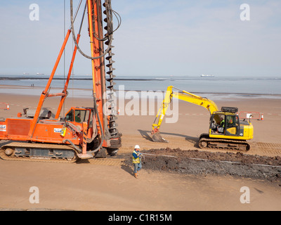 Arbeiter mit einem Maßband im Bau einer neuen Deich am Strand von Redcar Cleveland North Yorkshire März 2011 Stockfoto