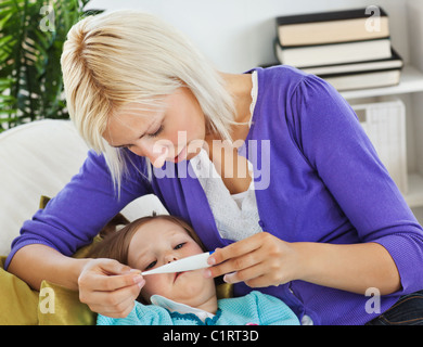 Mutter kümmert sich um ihr krankes Kind Stockfoto