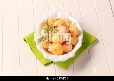 Schüssel mit Pfanne Bratkartoffeln garniert mit Käse überbacken Stockfoto