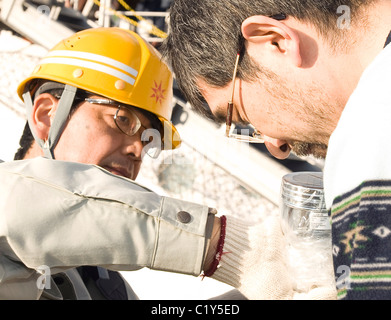 Mitglied der so genannten Fukushima 50 ist einen Strahlung Check vor dem Einstieg in die Kaiwomaru gegeben. Stockfoto