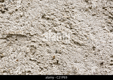 Textur auf den Beton und Kies machen an der Wand eines Gebäudes. Stockfoto