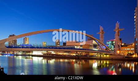 England, Greater Manchester, Salford Quays, Lowry Centre und Brücke bei Dämmerung beleuchtet Stockfoto