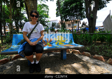 Frau sitzt auf einer dekorativen Bank am wichtigsten Platz, Embu Das Artes, Sao Paulo, Brasilien Stockfoto