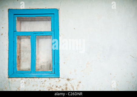 Alte Risse Wand mit Fenster blau lackiert Stockfoto