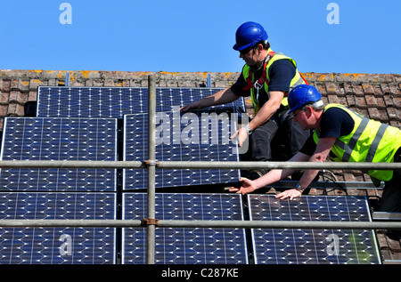 Sonnenkollektoren installiert wird, auf ein Haus Dach, England, UK Stockfoto