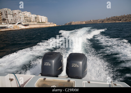 Ein Speed-Boot mit zwei Yamaha 225 Außenbord Motoren schaffen eine Totenwache hinter dem Boot. Stockfoto