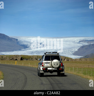 SUV fahren mit Flaajokull-Gletscher im Hintergrund, Ost-Island Stockfoto