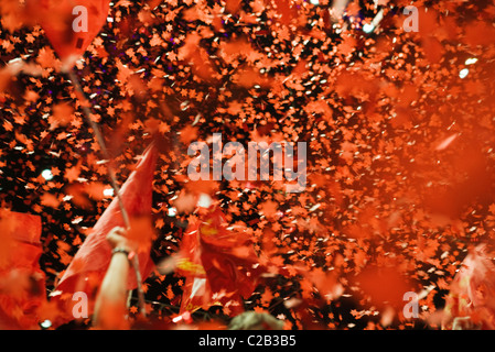 Menge jubeln, Fahnen und Konfetti in die Luft Stockfoto