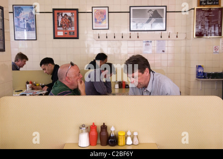 Zucker, Ketchup, Braune Sauce, Essig, Senf, Salz, Pfeffer Gewürzflaschen auf dem Tisch. Cafe Soße Flaschen Leute in der Mittagszeit, die mittags essen. Regency Cafe Westminster London SW1 UK. 2010er Jahre HOMER SYKES Stockfoto