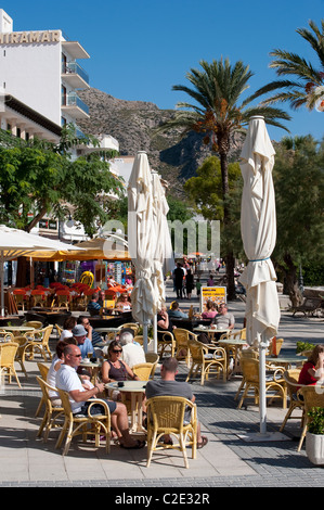 Urlauber, die Entspannung vor einem Café-Restaurant in der hübsche spanische Ferienort Puerto Pollensa. Stockfoto