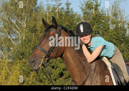 Glückliche junge Reiter auf einem Hannoveraner Rasse Pferd Stockfoto