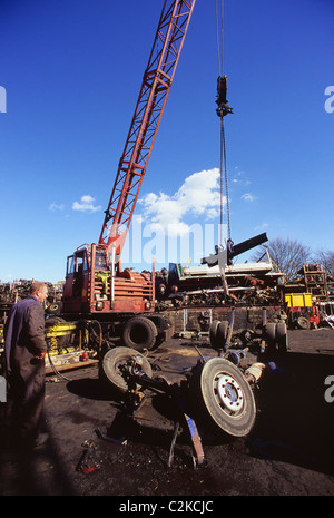 Kran heben LKW Achse von LKW-Fahrgestell für die Wiederverwertung Schrottplatz UK Stockfoto