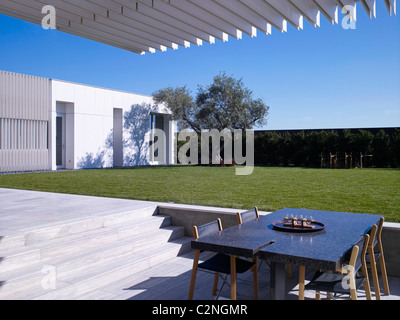 Modernes Einfamilienhaus, West Hollywood, Kalifornien. Essbereich mit Tisch und Stühlen im Schatten Stockfoto