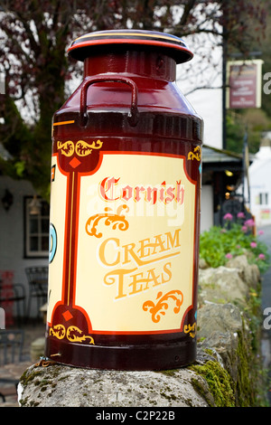 Milchkanne dekoriert, Cornish Cream Teas werben / Creme Tee Werbung in Polperro. Cornwall. VEREINIGTES KÖNIGREICH. Stockfoto