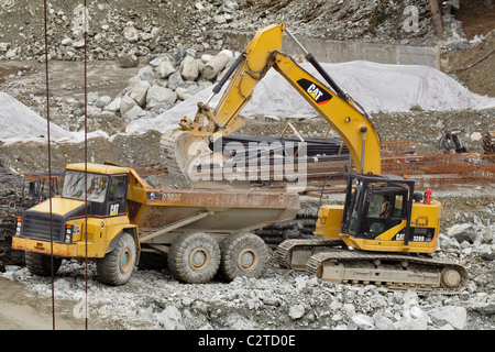 Bagger laden große Felsen auf riesigen Muldenkipper auf Bau Website-Victoria, British Columbia, Kanada. Stockfoto