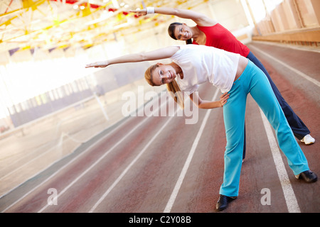 Zwei junge Mädchen machen Übungen synchron Stockfoto