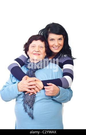 Schöne Enkelin umarmt ihre Großmutter isoliert auf weißem Hintergrund Stockfoto