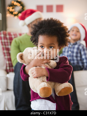 Schwarzes Mädchen umarmt Teddybär Stockfoto