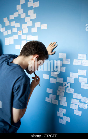 Teenager, die Überarbeitung für Mathematik A-Level mit Überarbeitung Karten stecken auf seiner Schlafzimmerwand. Stockfoto