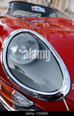 Detail-Schuss des Scheinwerfers einen roten Jaguar E-Type Oldtimer britischer Sportwagen Stockfoto