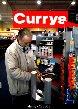 Ein Kunde von Currys Latop und Mobilelektronik Bereich in einem Geschäft durchsuchen. Stockfoto