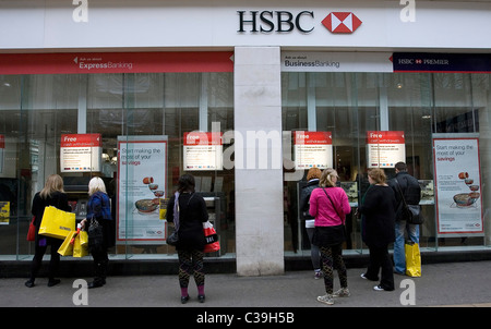 Kunden Schlange vor einer HSBC Filiale im Zentrum von London, das Geld zeigen Einrichtungen Stockfoto